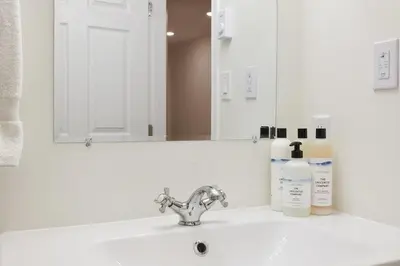 a bathroom sink with a mirror and a white sink at NN - The Névé - Crestview 1-bed 1-bath in Whitehorse
