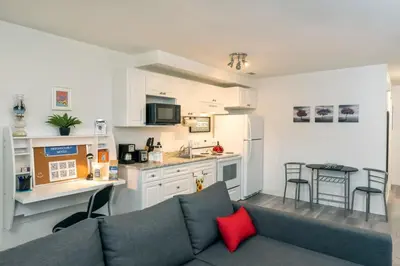 a living room with a couch and a kitchen at NN - The Evelyn - Whistlebend 1-bed 1-bath in Whitehorse