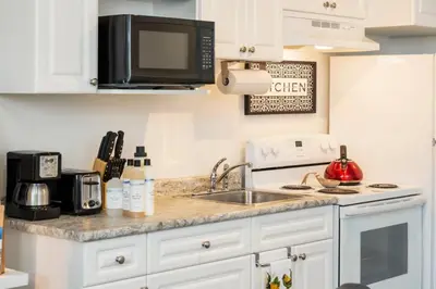 a kitchen with a sink and a microwave at NN - The Evelyn - Whistlebend 1-bed 1-bath in Whitehorse