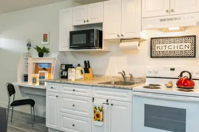 a kitchen with white cabinets and a microwave at NN - The Evelyn - Whistlebend 1-bed 1-bath in Whitehorse