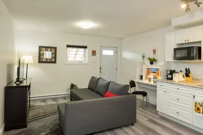 a living room with a couch and a kitchen at NN - The Evelyn - Whistlebend 1-bed 1-bath in Whitehorse