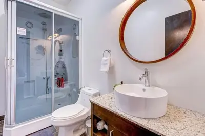 a bathroom with a sink and a shower and a toilet at Mountain Retreat, Pool & Hot Tub, BBQ, Patio, King Bed, Sleeps 6! in Canmore