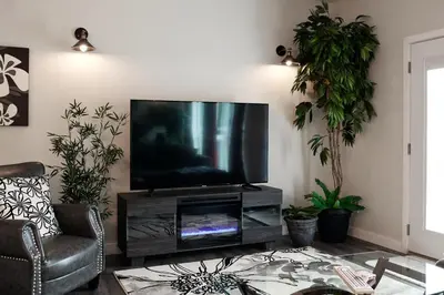 a living room with a flat screen tv on a entertainment center at NN - The Kit - Downtown 1-bed 1-bath in Whitehorse