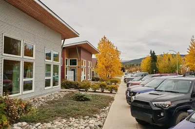 a row of parked cars parked next to a house at NN - The Kit - Downtown 1-bed 1-bath in Whitehorse