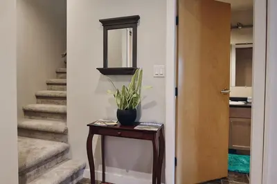 a hallway with a table with a potted plant on it at NN - The Kit - Downtown 1-bed 1-bath in Whitehorse