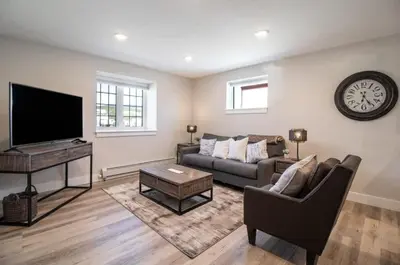 a living room with a couch and a tv at NN - Flats on 4th #1 - Downtown 2-bed 2-bath in Whitehorse