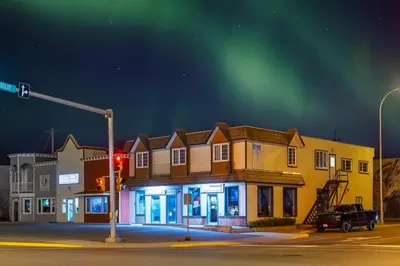 a building on a street corner with a traffic light at NN - Flats on 4th #1 - Downtown 2-bed 2-bath in Whitehorse
