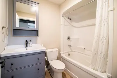 a bathroom with a sink and a toilet and a tub at NN - Flats on 4th #1 - Downtown 2-bed 2-bath in Whitehorse