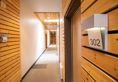 a hallway with wood paneling and a number on the wall at NN - Park View #1 - Downtown 2-bed 2-bath in Whitehorse