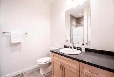 a bathroom with a sink and a toilet and a mirror at NN - Park View #1 - Downtown 2-bed 2-bath in Whitehorse