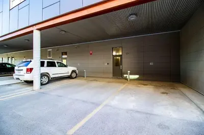 a white suv parked in a parking lot at NN - Park View #2 - Downtown 2-bed 2-bath in Whitehorse