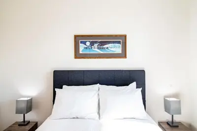 a bedroom with a bed and a picture on the wall at NN - Park View #2 - Downtown 2-bed 2-bath in Whitehorse