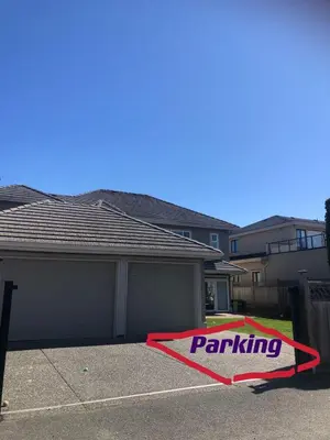 a house with a parking sign in a driveway at independent entrance cozy room with private bathroom close to YVR Richmond in Richmond