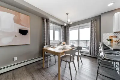 a dining room with a table and chairs at Peaceful Oasis Condo, AC, Top Floor, Secure UG Parking, Balcony, King Bed! in Edmonton