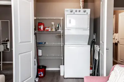 a kitchen with a white refrigerator and a shelf at Peaceful Oasis Condo, AC, Top Floor, Secure UG Parking, Balcony, King Bed! in Edmonton
