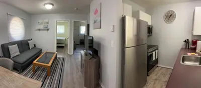 a kitchen and a living room with a refrigerator at Lovely 2 bedroom condo, 2 minute walk fr downtown in Invermere