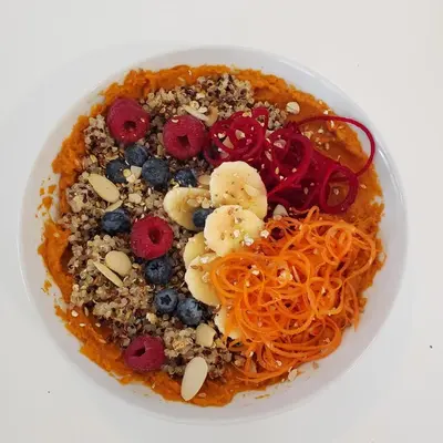 a bowl of food with pasta and fruit and nuts at Global Village Permaculture BnB in Oliver
