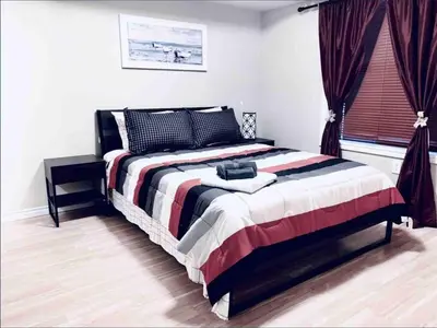 a bedroom with a large bed in a room at 2 BDRM A/C Condo w/Ensuite Laundry + Free Parking in Edmonton