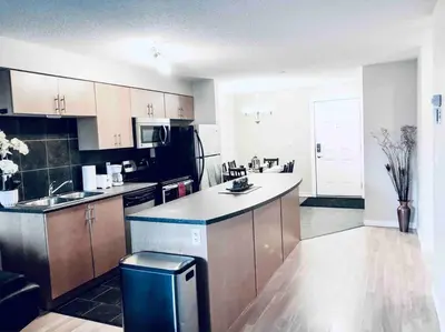 a large kitchen with a counter top and a kitchen sidx sidx sidx sidx at 2 BDRM A/C Condo w/Ensuite Laundry + Free Parking in Edmonton