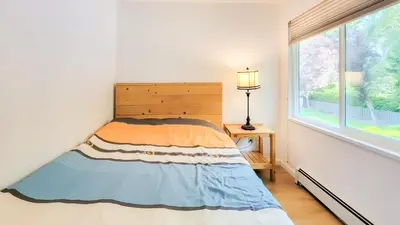 a bedroom with a bed and a window at Ocean Park B&B in Surrey