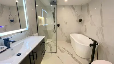 a bathroom with a sink and a shower and a toilet at 2BR plus Loft, Modern and Spacious, Hot Tub and Sauna, Private Balcony, Fireplace in Whistler