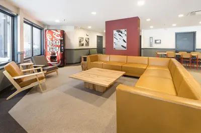 a waiting room with a couch and a table and chairs at The Approach Hotel in Panorama