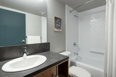a bathroom with a sink and a toilet and a tub at The Approach Hotel in Panorama