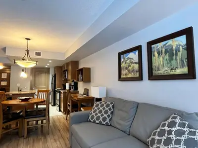 a living room with a couch and a dining room at Perfect family 2-bed Condo with hot tub in Dead Man's Flats