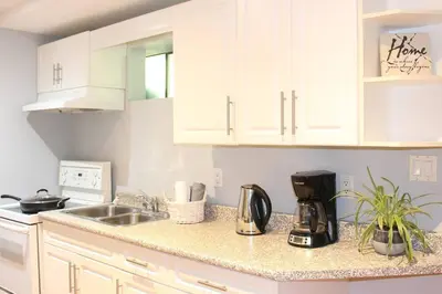 a kitchen with white cabinets and a sink at 2-Bedroom basement suite with a separate entrance. in Abbotsford