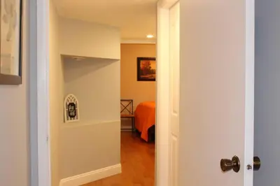 a hallway with a door leading to a bedroom at 2-Bedroom basement suite with a separate entrance. in Abbotsford
