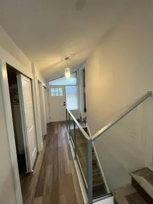 an empty hallway with stairs and a door in a house at Escape to Spring Gate Estate in Victoria