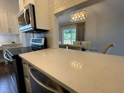 a kitchen with a counter top and a dining room at Escape to Spring Gate Estate in Victoria