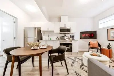 a kitchen with a table and chairs in a room at Cozy Nordic Utopia, Bsmt Suite near WEM & DT, King Bed, WiFi in Edmonton