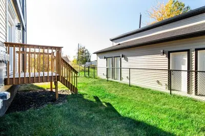 a deck on the side of a house at Cozy Nordic Utopia, Bsmt Suite near WEM & DT, King Bed, WiFi in Edmonton