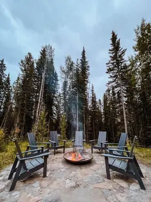 a group of chairs sitting around a fire pit at Okt Häus in Nordegg