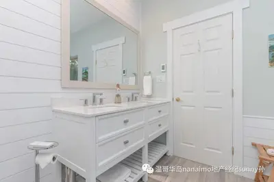 a white bathroom with a sink and a mirror at luxury ocean dock pool villa in Ladysmith