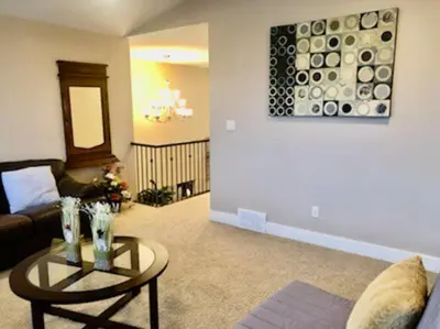 a living room with a couch and a table at Luxury 3700 sq/ 5 bedroom/ jettedtub/ 4 fireplaces in Edmonton