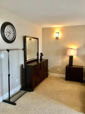 a room with a mirror and a dresser and a clock at Luxury 3700 sq/ 5 bedroom/ jettedtub/ 4 fireplaces in Edmonton