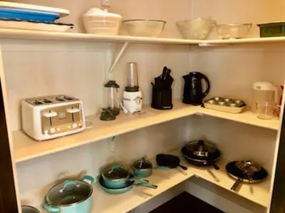 a kitchen shelf with pots and pans and a toaster at Luxury 3700 sq/ 5 bedroom/ jettedtub/ 4 fireplaces in Edmonton