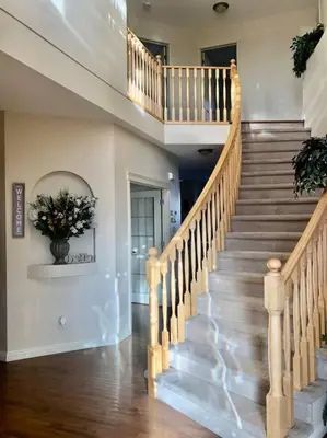 a staircase in a house with a vase of flowers at 2500 sq house in Springbank Hill BL 261818 in Calgary
