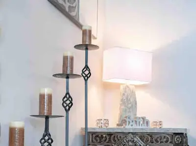 a room with three candles and a table with a lamp at 2500 sq house in Springbank Hill BL 261818 in Calgary