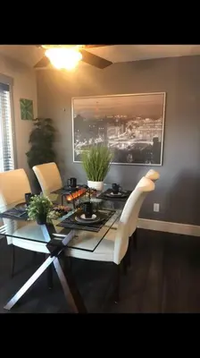a dining room with a glass table and chairs at Cozy and beautiful 3 bedroom house close to lake in Edmonton