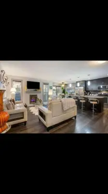 a living room with two white couches and a tv at Cozy and beautiful 3 bedroom house close to lake in Edmonton
