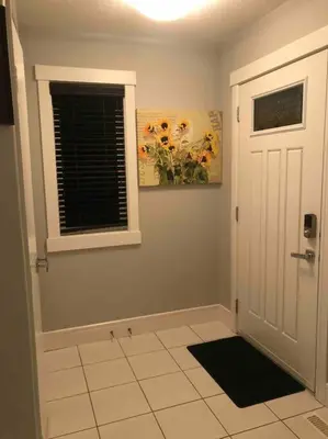 a room with a white door and a window and a tile floor at Cheerful and beautiful 3 bedroom home close lake in Edmonton