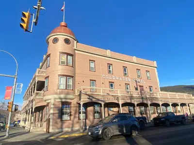 a building on a street with cars parked in front of it at Coldwater Hotel in Merritt