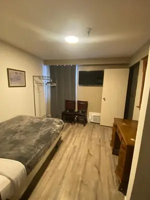 a hotel room with a bed and a desk at Coldwater Hotel in Merritt