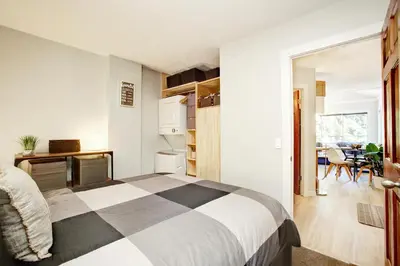 a bedroom with a bed and a dining room at Gondola Haus - Free parking in Whistler