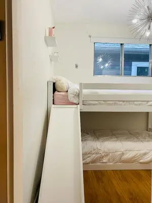 a small bedroom with bunk beds with a window at Trendy Kensington 3 min Walk Backyard AC Garage in Calgary