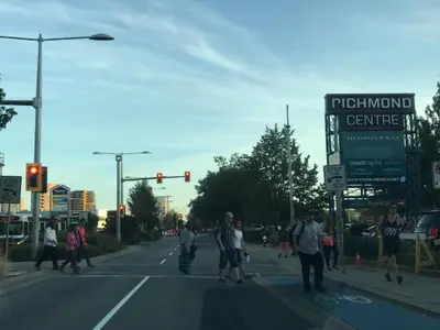 a group of people crossing the street at an intersection at Xin Xin House in Richmond