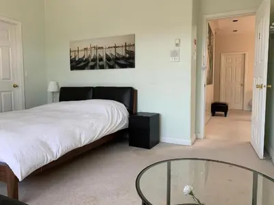 a bedroom with a bed and a glass table at Xin Xin House in Richmond